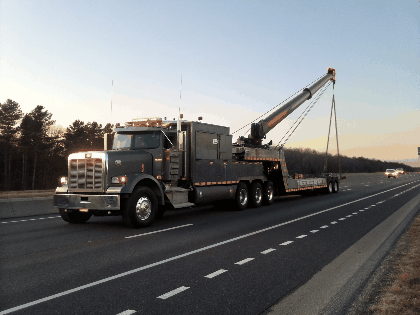 Heavy duty tow truck assisting a large commercial vehicle