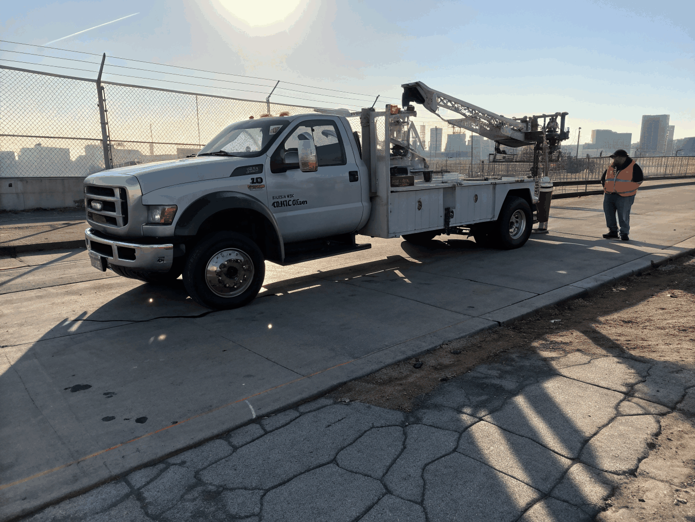 Medium duty tow truck hauling a commercial delivery vehicle